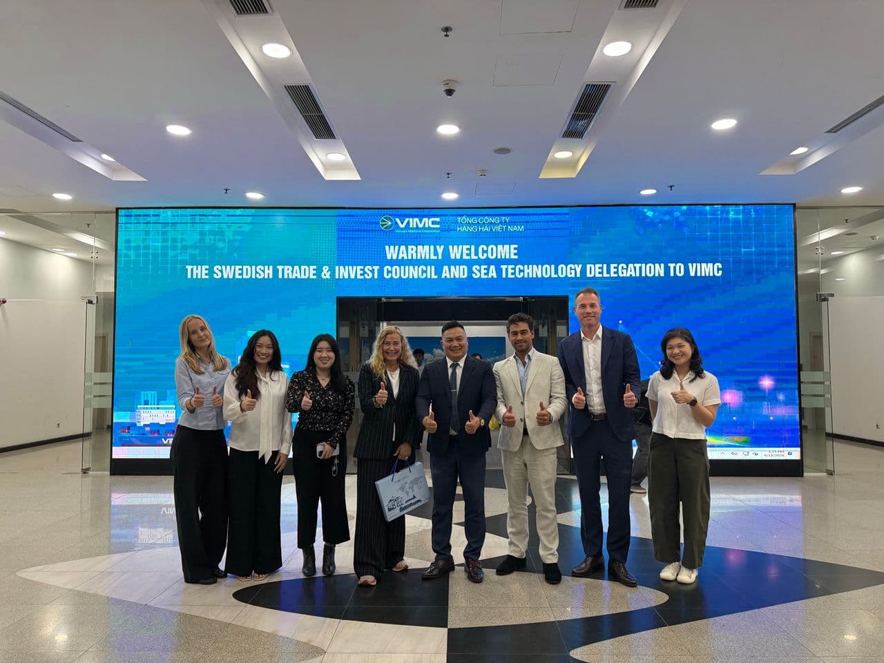 The Business Sweden and Sea Technology delegation in front of a welcome screen in Vietnam
