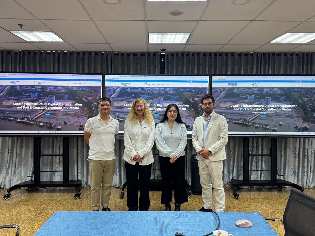 Sea Technology team members with hosts in front of port maps in Vietnam